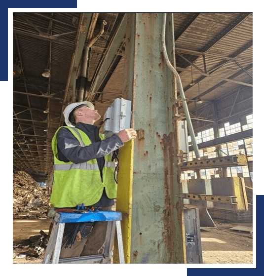 HSI Security Technician in a Factory installing a new switchboard